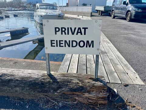 Private property, privat eiendom sign on the beach in Norwegian 