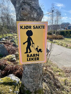 warning sign on the road kj&oslash;r sakte barn leker or drive slowly children playing