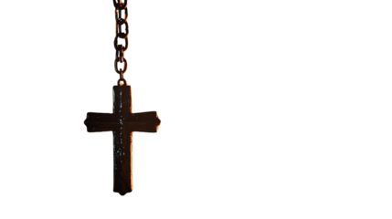 Symbolic cross hanging near a cozy fire in a spiritual setting