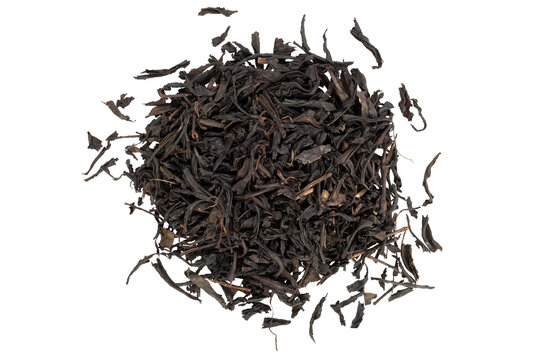 Close-up of a pile of black tea leaves. Isolation on transparent background.