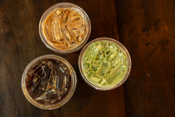 Party ice cool drink.Top view hand holding black coffee, espresso and matcha green tea at coffee shop.Friends having a coffee menu and talking at a cafe.