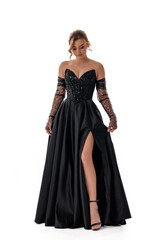 Fototapeta premium Elegant woman in a black evening gown posing gracefully for a fashion showcase