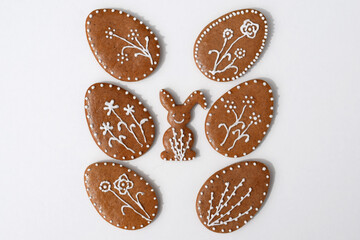 Romantic decorated Easter gingerbread cookies in a shape of egg and bunny, white background