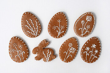 Romantic decorated Easter gingerbread cookies in a shape of egg and bunny, white background