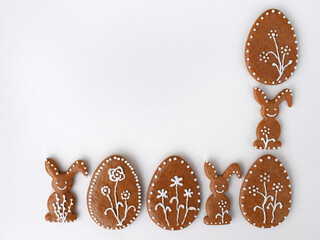 Romantic decorated Easter gingerbread cookies in a shape of egg and bunny, white background, copy space for text