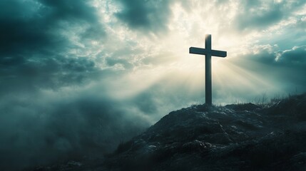 Christian cross on hill with dramatic sky background for easter and good friday remembrance concept
