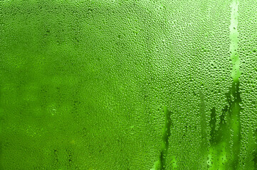 drops of water on the glass. green background