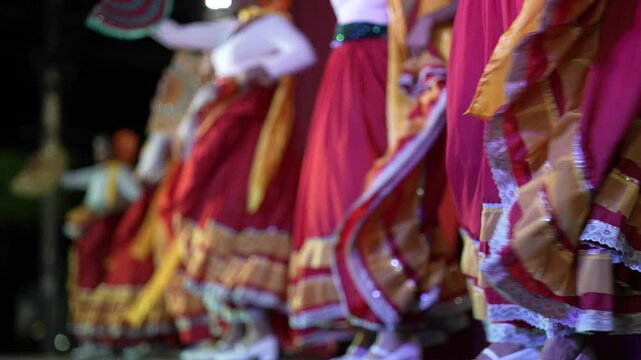Women in vibrant traditional dresses perform a slow motion folk dance in Granada Nicaragua, celebrating cultural heritage through movement and music during a local event.