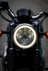  a close up of a motorcycle headlight on a street, with the background blurred The headlight is in focus, while the background is slightly blurred, giving the image