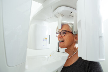 Senior woman undergoing panoramic dental x ray examination