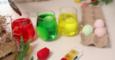Enjoy the joy of Easter egg dyeing with colorful liquids and beautifully decorated eggs in a creative setting