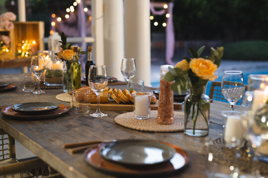 Elegant dinner table set with candles and flowers, ready for celebration