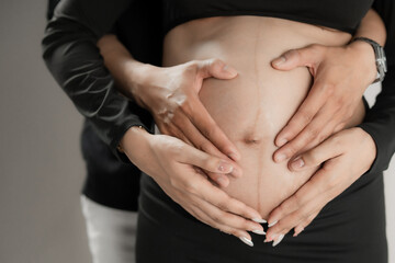 pregnant woman holding her belly