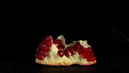 Delicious and fresh pomegranate, a bright fruit on a dark background