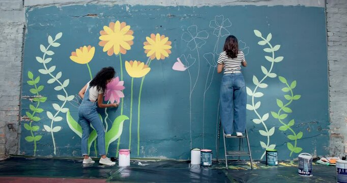 Back, people and friends for painting of wall for creative mural, community project and artistic freedom. Women, artist and public art in city, flower design and local culture for therapeutic hobby