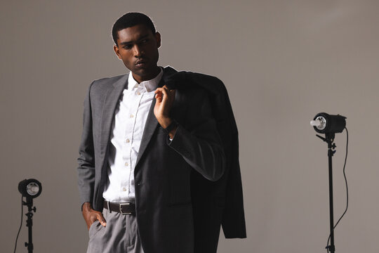 Confident man in stylish suit posing in professional photography studio