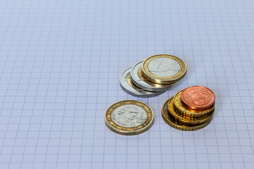 Coins neatly folded on checkered paper, Business series (part of a series).