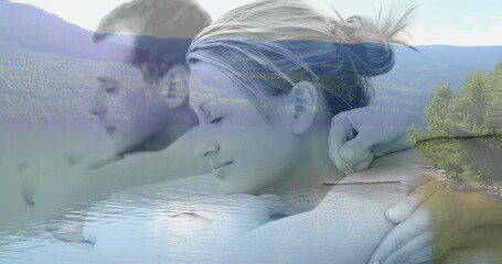 Digital composite of couple enjoying a relaxing back massage, with peaceful lake surrounded by green