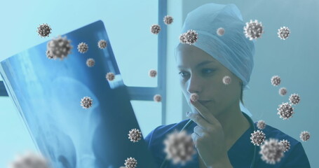 Analyzing X-ray in hospital, medical professional surrounded by virus illustrations