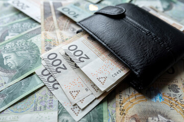 100 200 Polish zloty PLN banknote in black wallet
