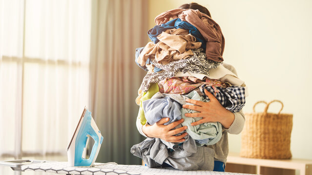 Housewife with a pile of laundry to iron