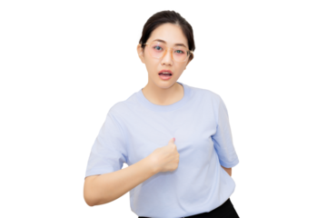 A woman in a light blue shirt gestures expressively, showcasing a confident and engaging demeanor.