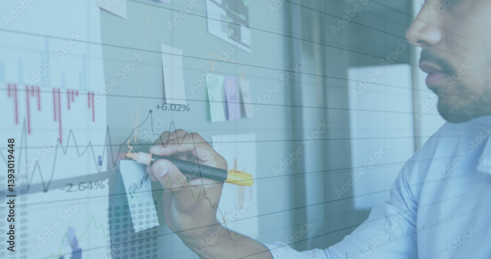 Poster image of interface with graphs and data with man in office making notes on wall