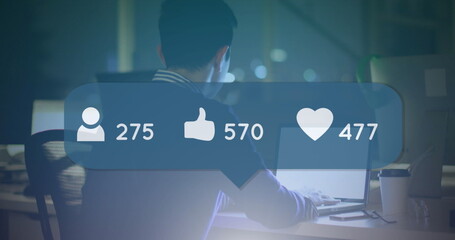 Image of speech bubble with social media icons over man using laptop