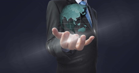 Image of globe spinning over businessman hand in background