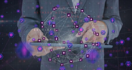 Image of globe with digital icons over businessman using tablet