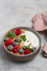 yogurt with granola, oatmeal, raspberries, mint, blueberries, breakfast