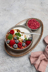 yogurt with granola, oatmeal, raspberries, mint, blueberries, breakfast