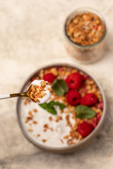 yogurt with granola and raspberries, breakfast