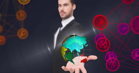 Image of network of connections with icons over businessman holding globe