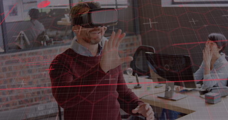 Hexagonal shapes and data processing against caucasian man wearing vr headset at office