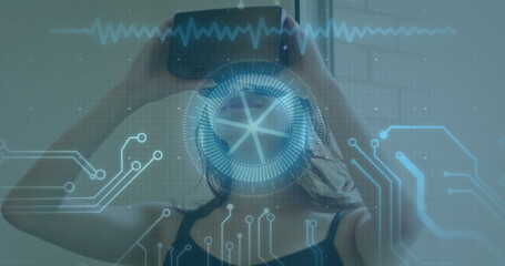 Image of scope scanning and data processing over woman wearing vr headset