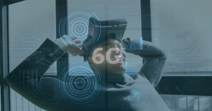 Image of 6g text, scopes scanning and data processing over smiling man wearing vr headset