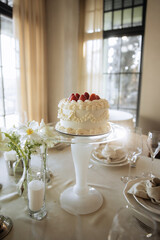 Elegant White Cake with Strawberries on Glass Stand
