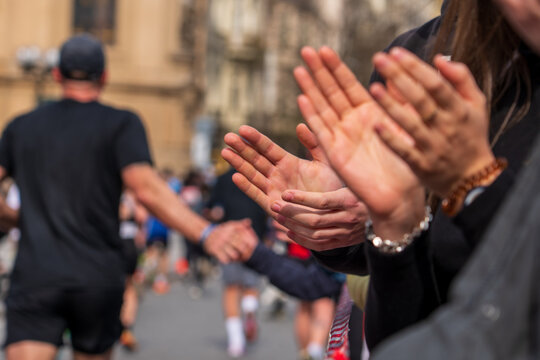 Prague, Czech Republic - April 5, 2025: Generali Half Marathon Prague 2025. The runner greets the fan with his hand. People clap the palm of a runner.