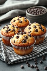 Chocolate chip muffins on a plate on a light gray background. Top view