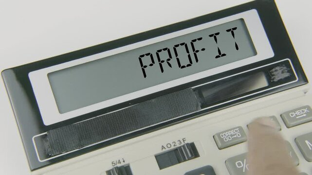 Profit text or words displayed on a calculator's LED screen as a hand types numbers, symbolizing the process of calculating financial gain or loss in business operations, highlighting success