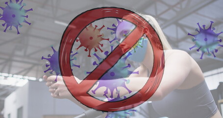 Stop sign over covid-19 cells moving against caucasian woman using smartphone at the gym