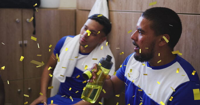 Image of confetti falling over male football players in changing rooms