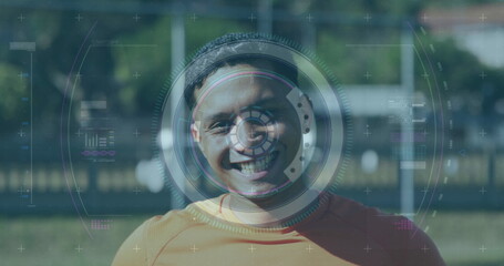 Scope scanning over digital interface with data processing against male soccer player smiling
