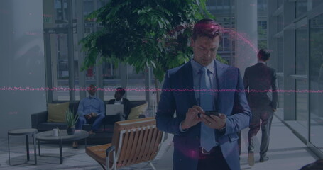 Image of globe spinning over businessman using smartphone