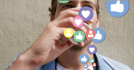 Image of social media icons over man drinking coffee