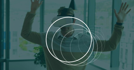 Image of white circles moving over man wearing vr headset using virtual interface