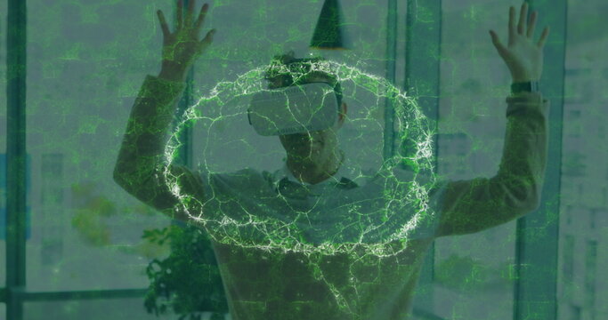 Image of human brain and medical data processing over businessman wearing vr headset