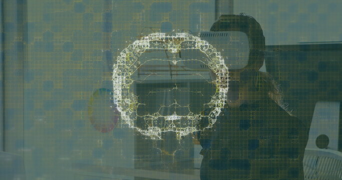 Image of human brain and medical data processing over businesswoman wearing vr headset