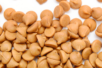 Close up pile of chocolate morsels on white background